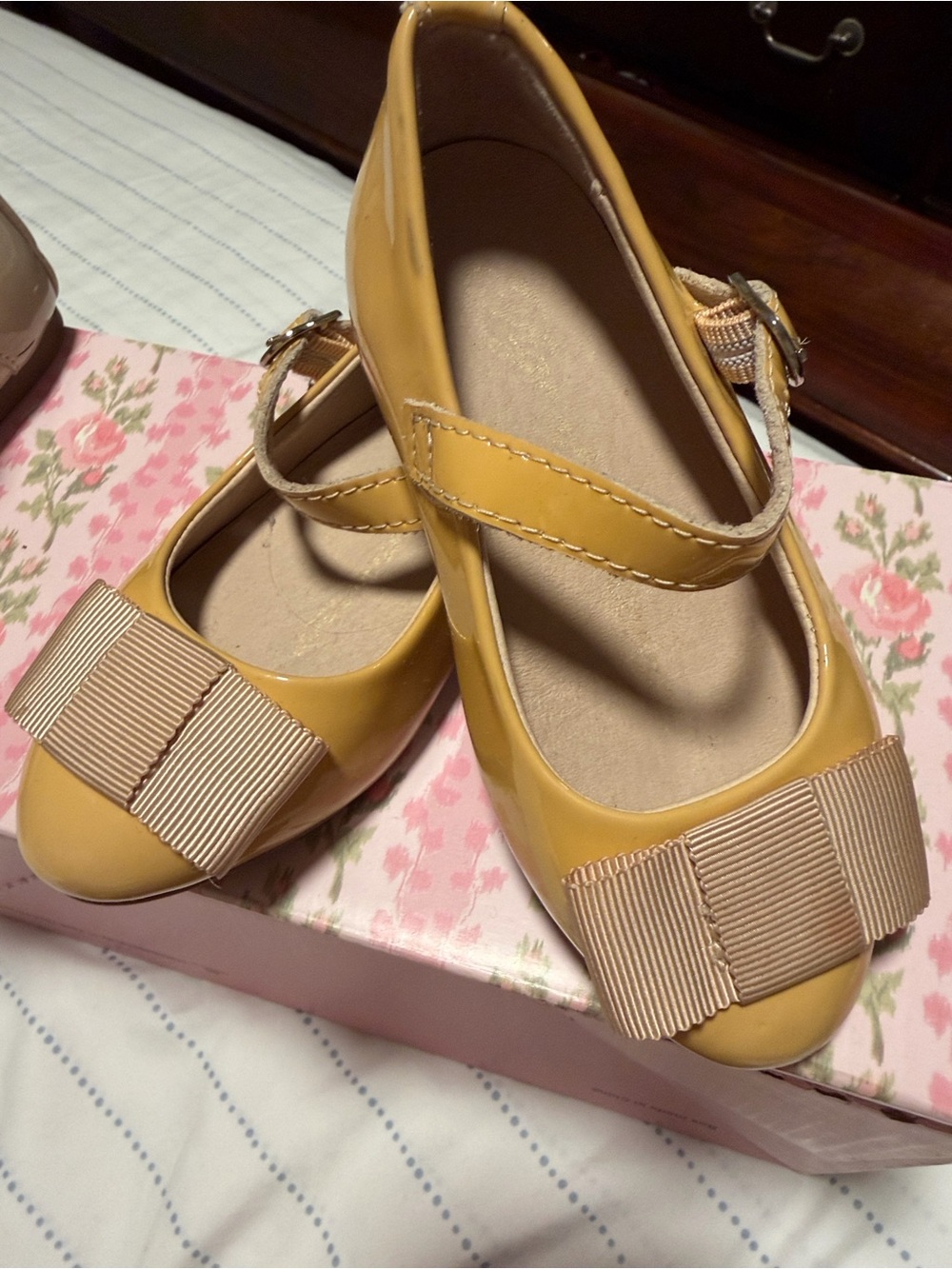 Girls' nude Mary Jane Flats with Grosgrain Bow Accent.